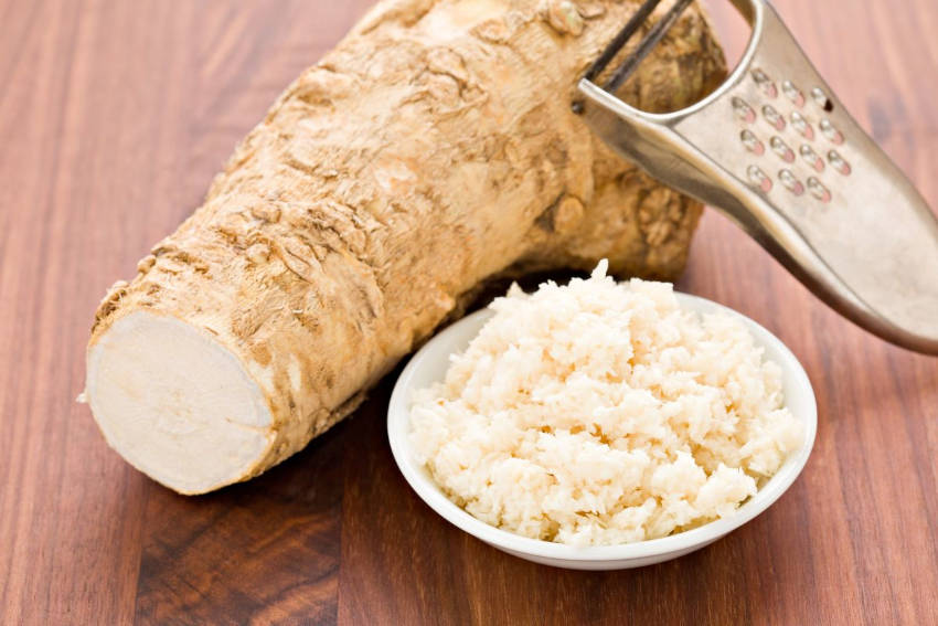 A horseradish root with grated horseradish