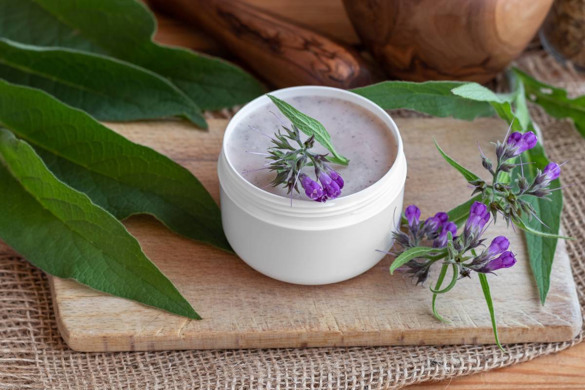 A small bowl of comfrey skincare ointment