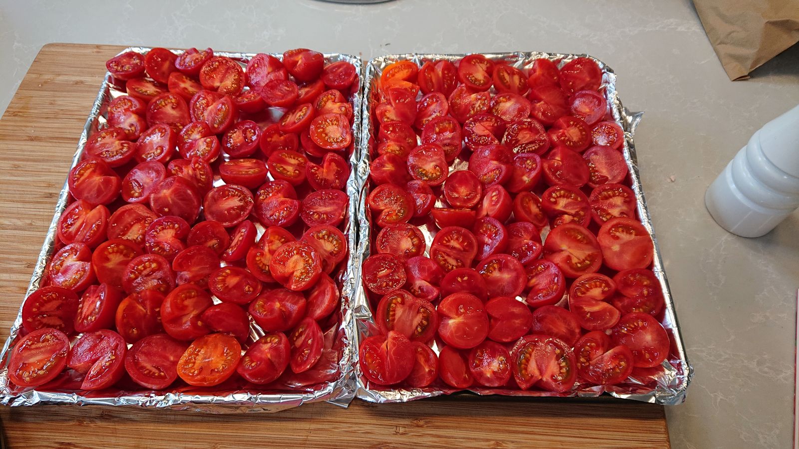 Tomatoes cut in half and placed on a baking tray