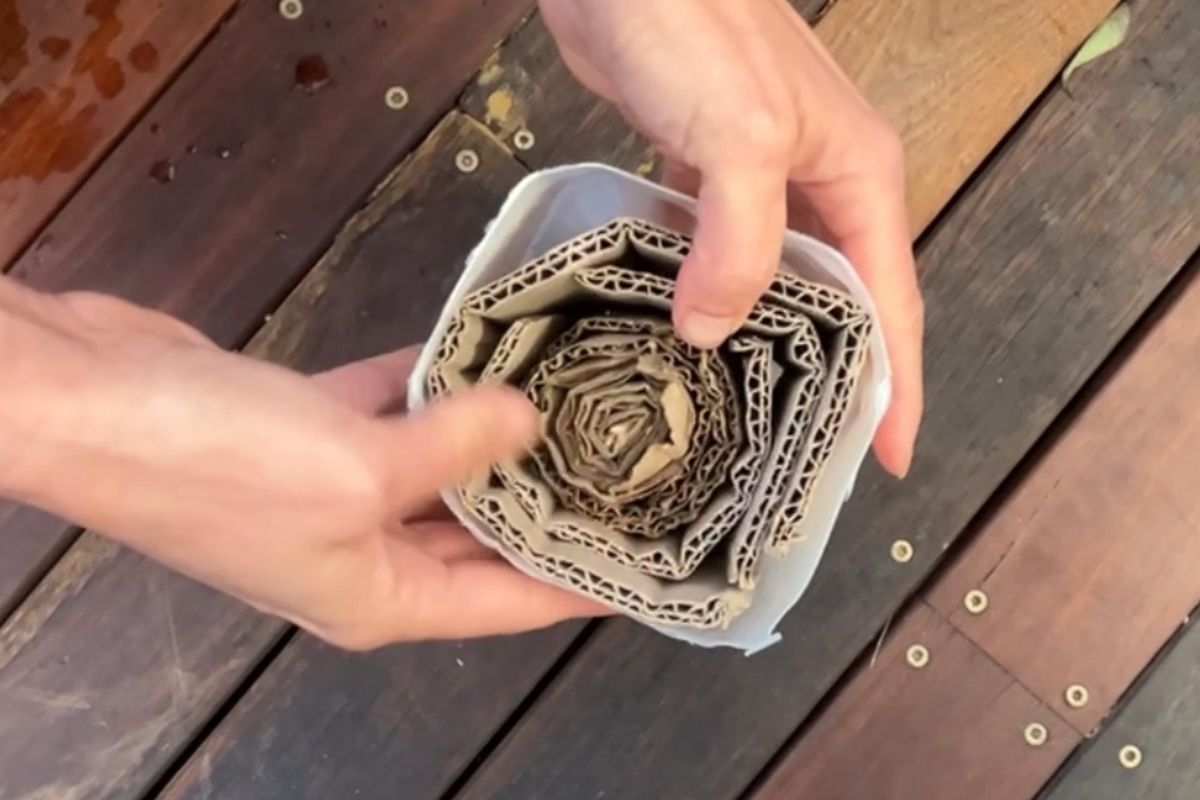 Rolling the cardboard tightly