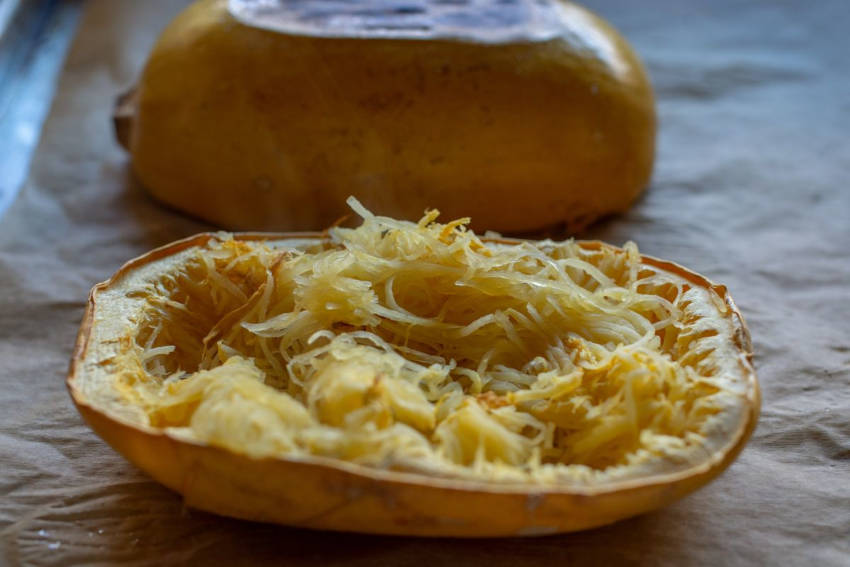Two halves of a baked spaghetti squash