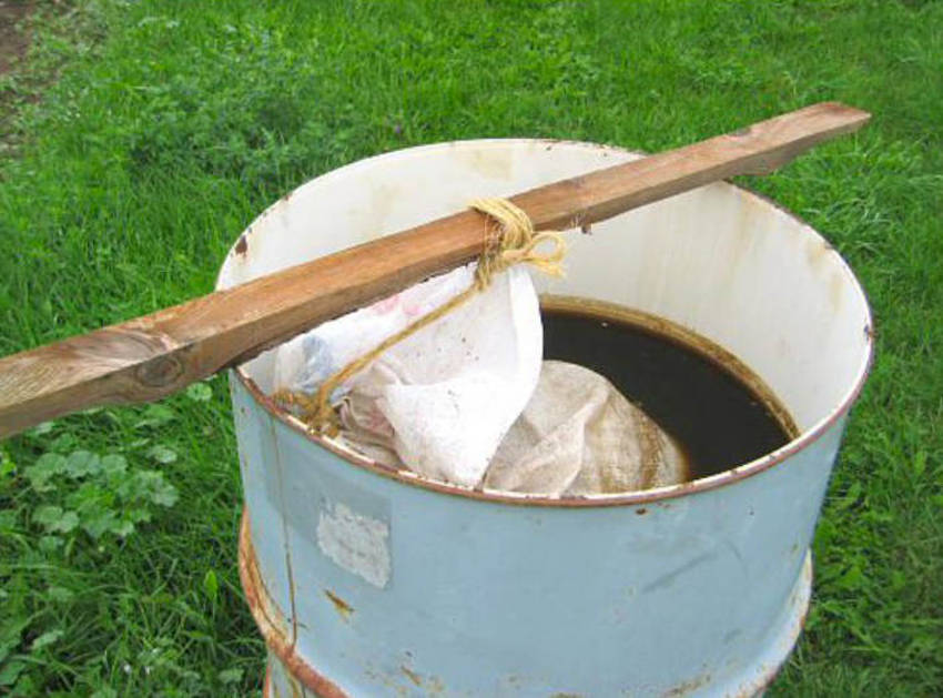 A bucket of liquid fertiliser being brewed