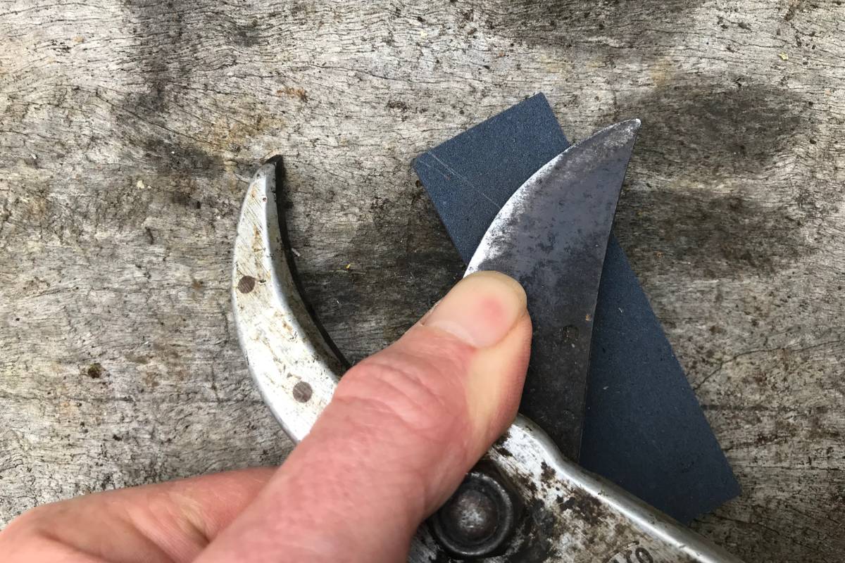 rubbing the blade on an angle over the sharpening stone